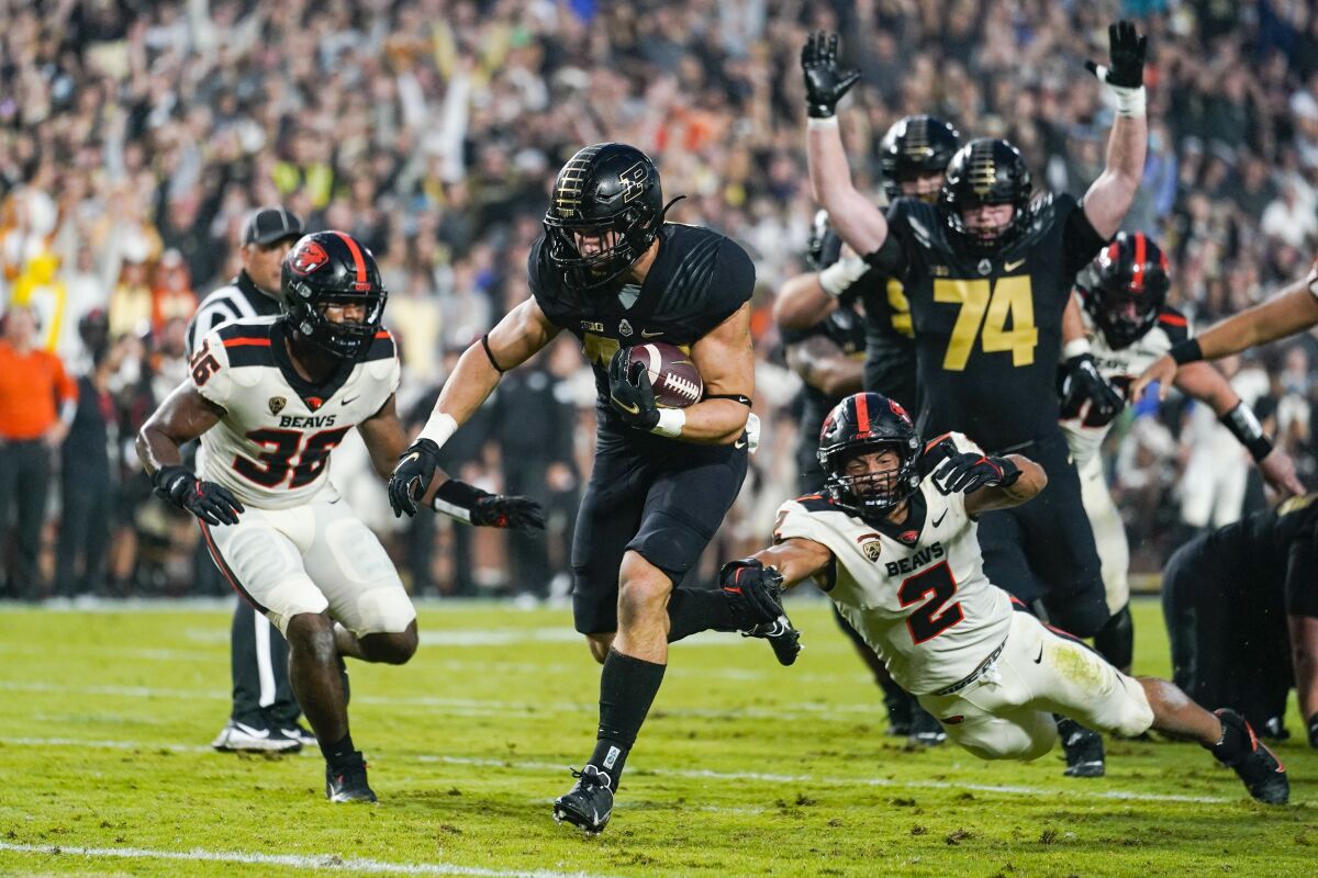 Purdue running back Zander Horvath (40) runs past Oregon State linebacker Andrzej Hughes-Murray (2) for a touchdown during the first half of an NCAA college football game in West Lafayette, Ind., Saturday, Sept. 4, 2021. (AP Photo/Michael Conroy)