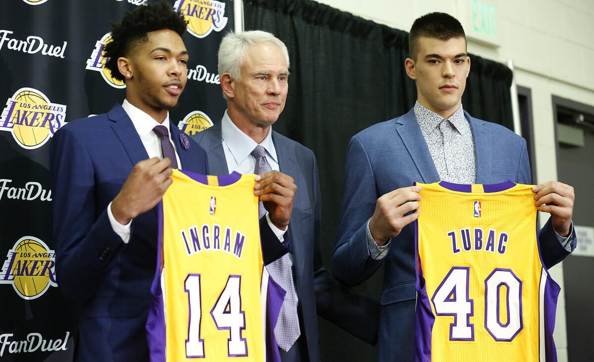 Lakers draft picks Brandon Ingram (14) and Ivica Zubac (40) with General Manager Mitch Kupchak, are introduced at a news conference at the team's training facility.
