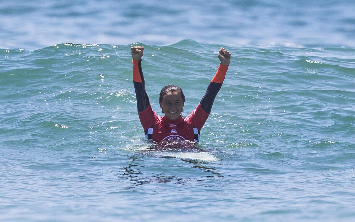 Johanne Defay of France raises her arms in victory after wining the Vans U.S. Open of Surfing in Huntington Beach.