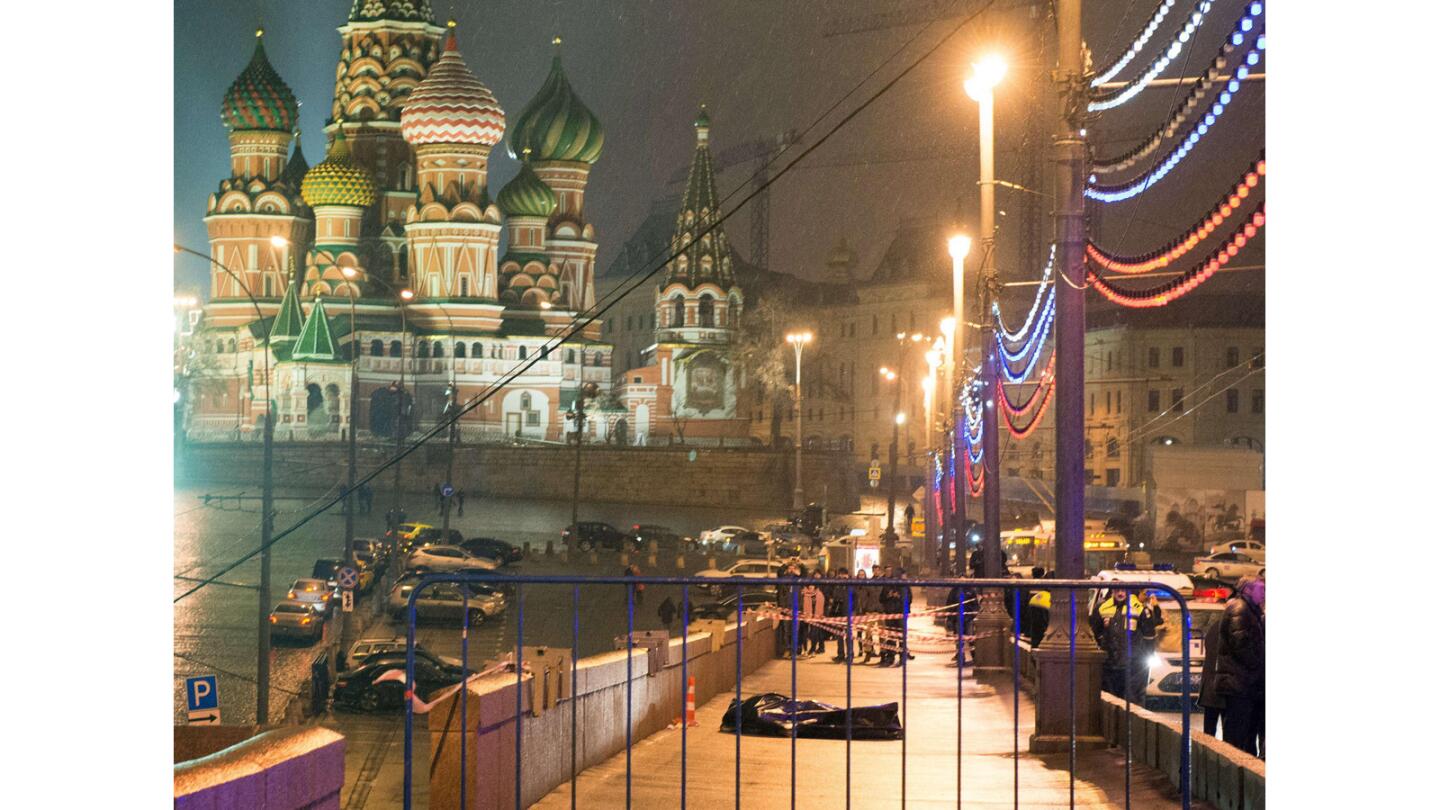 The body of Russian opposition leader Boris Nemtsov is covered with a plastic tarp on Moskvoretsky bridge near St. Basil Cathedral.