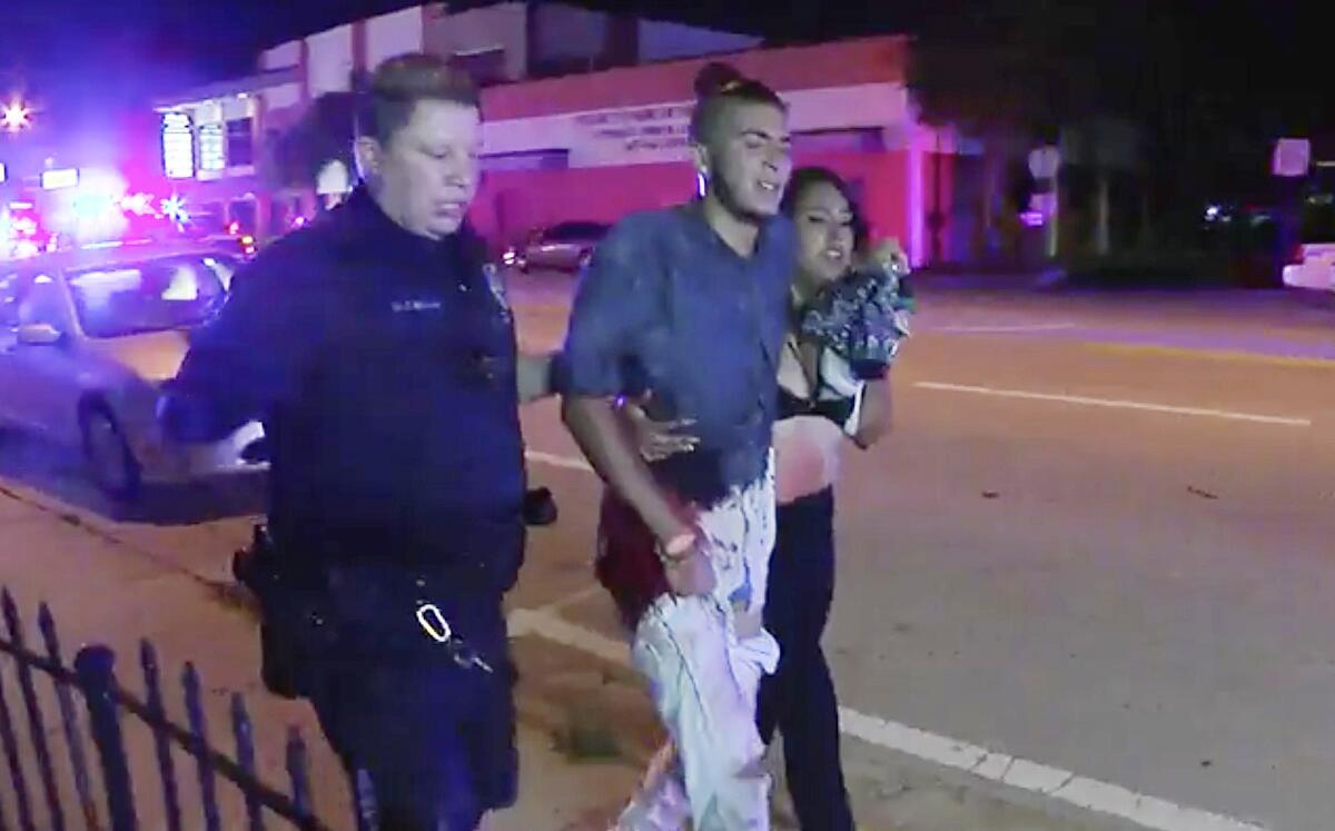 An injured man is escorted out of the Pulse nightclub in Orlando, Fla., after the shooting rampage that left 49 dead.