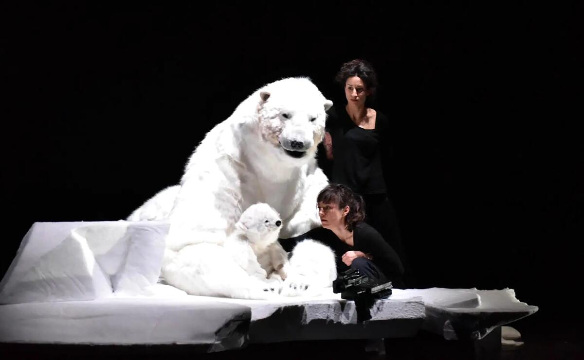 two performers with fake polar bears on stage 