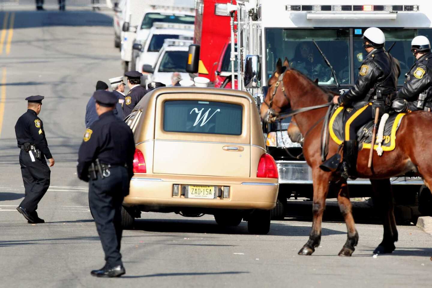 A hearse drives away from New Hope Baptist Church.