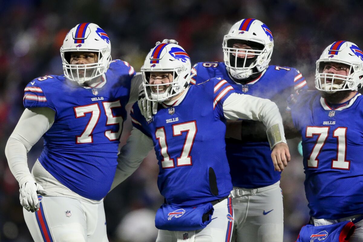 Buffalo Bills quarterback Josh Allen (17) celebrates after wide receiver Gabriel Davis (13) scores a touchdown during the second half of an NFL wild-card playoff football game against the New England Patriots, Saturday, Jan. 15, 2022, in Orchard Park, N.Y. (AP Photo/Joshua Bessex)