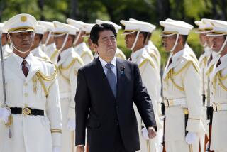 FILE - Then Japanese Prime Minister Shinzo Abe, center, reviews an honor guard in a ceremony prior to his meeting with high-ranked officers of the Japan Self-Defense Forces at the Defense Ministry in Tokyo on Sept. 12, 2013. Former Japanese Prime Minister Abe, a divisive arch-conservative and one of his nation's most powerful and influential figures, has died after being shot during a campaign speech Friday, July 8, 2022, in western Japan, hospital officials said.(AP Photo/Koji Sasahara, File)