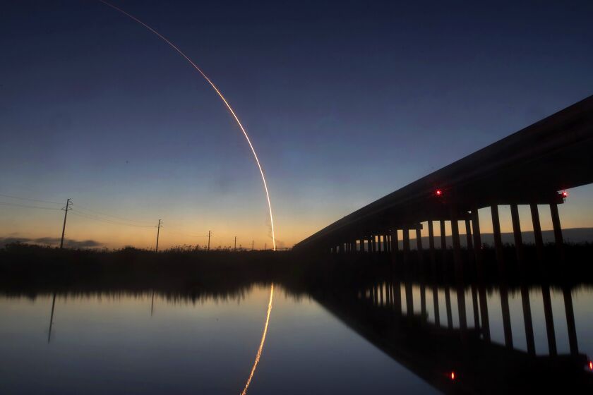 A United Launch Alliance Atlas V rocket carrying the Boeing Starliner crew capsule on an Orbital Flight Test to the International Space Station lifts off from Space Launch Complex 41 at Cape Canaveral Air Force station, Friday, Dec. 20, 2019, in this view from the St. Johns River east of Sanford, Fla. (Joe Burbank/Orlando Sentinel via AP)