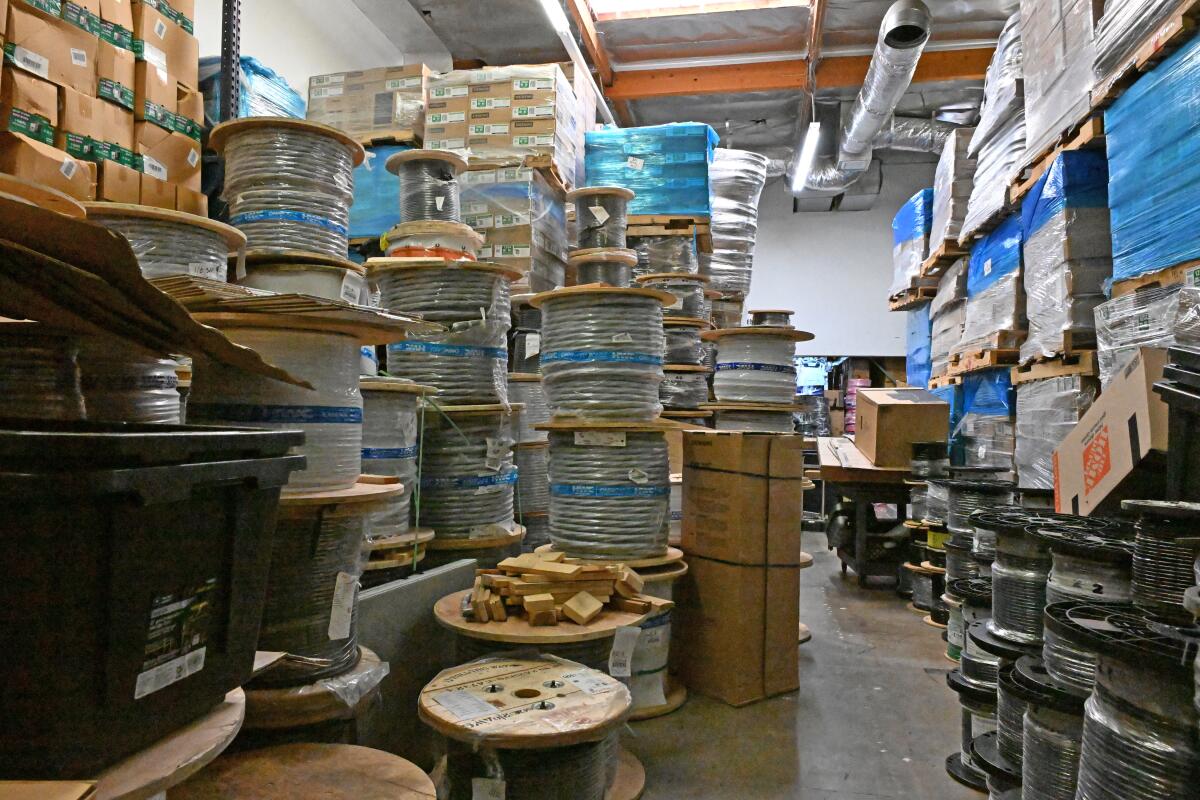 Piles of cable and boxes in a warehouse.