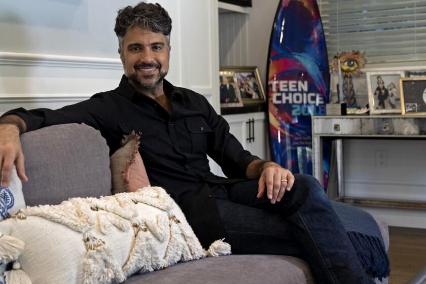 STUDIO CITY, CALIF. - DEC. 11, 2018 "Jane the Virgin" actor Jaime Camil enjoys spending time with the kids in his multi-purpose living room filled with comfortable furniture and fond memories. (Wesley Du / Los Angeles Times)