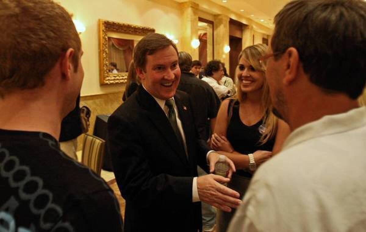 L.A. mayoral candidate Kevin James chats with guests after a candidates' forum in September.
