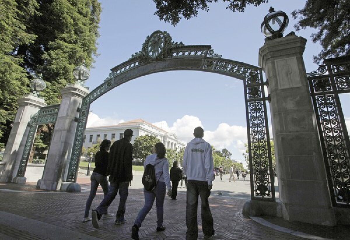 A group of students walk through the Sather Gate at UC Berkeley.