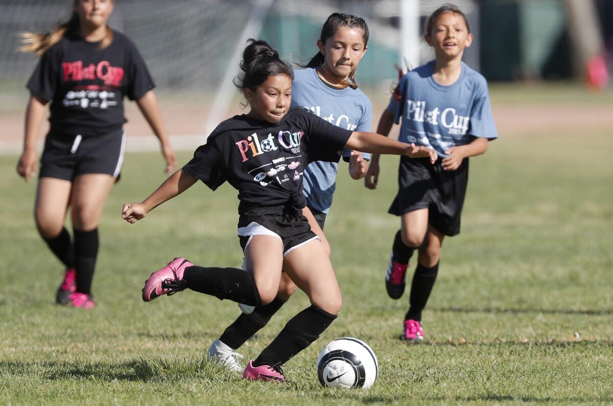 Rea Elementary's Ashley Flores clears the ball out of the back against College Park during a girls’ third- and fourth-grade Bronze Division pool-play match at the Daily Pilot Cup on Wednesday at Jack R. Hammett Sports Complex in Costa Mesa.