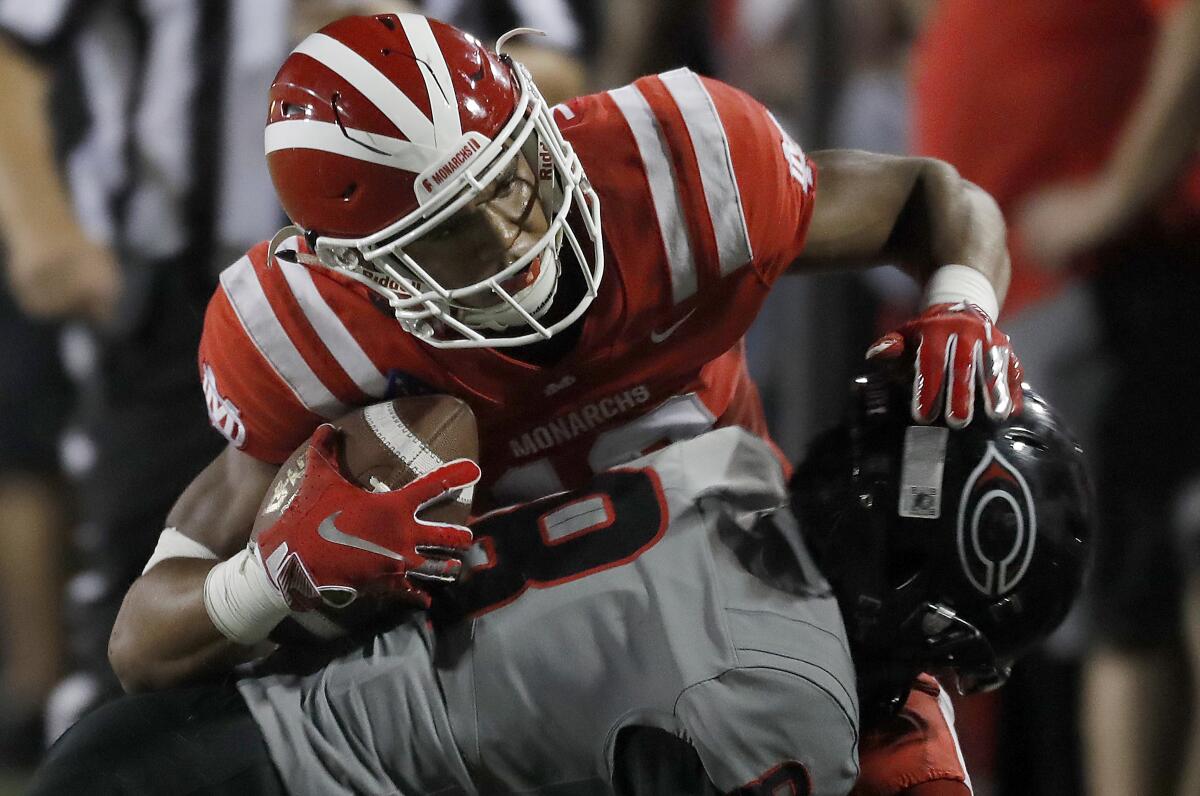 Mater Dei wide receiver Creistian Dixon makes a catch against Centennial cornerback Jaden Mickey during a game on Aug. 23.