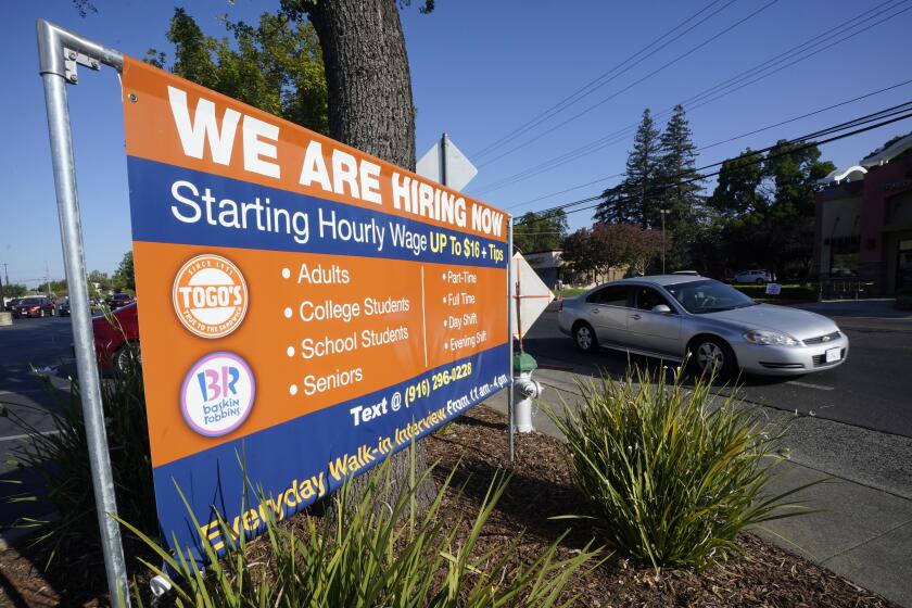 A car passes a hiring banner in Sacramento, Calif., Friday, July 16, 2021. Hiring in California slowed down in June 2021 as employers in the nation's most populous state tried to coax reluctant workers back into their pre pandemic jobs before the nation's expanded unemployment benefits expire in September. (AP Photo/Rich Pedroncelli)