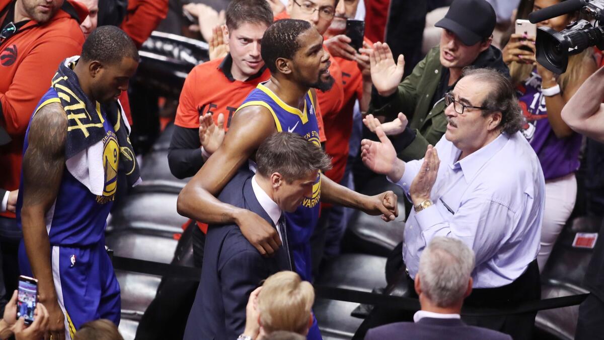 Golden State Warriors forward Kevin Durant is assisted off the court during the second quarter of Game 5 of the NBA Finals against the Toronto Raptors on June 10.