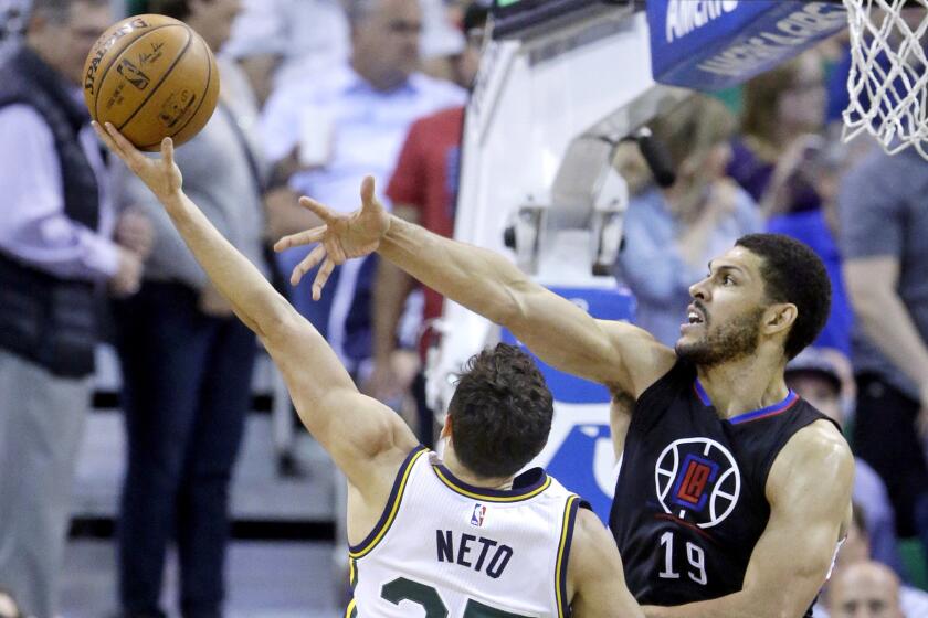 Clippers reserve forward Jeff Ayres forces Jazz guard Raul Neto to take an awkward shot during the first half Friday.