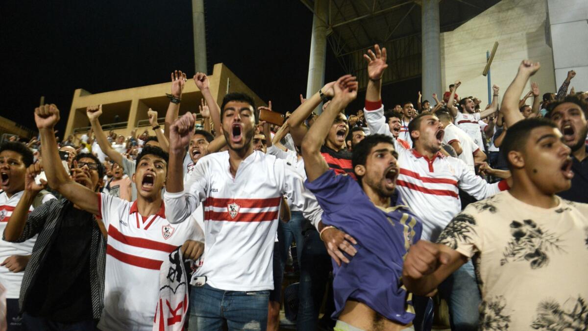 Fans cheer as Zamalek scores a goal at Petro Sport Stadium in Cairo.