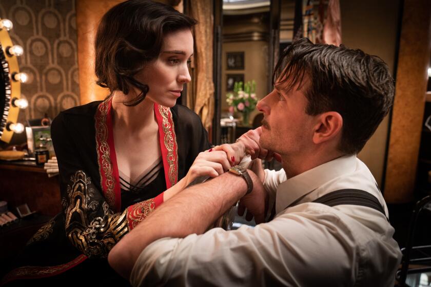 Rooney Mara and Bradley Cooper in “Nightmare Alley.” 