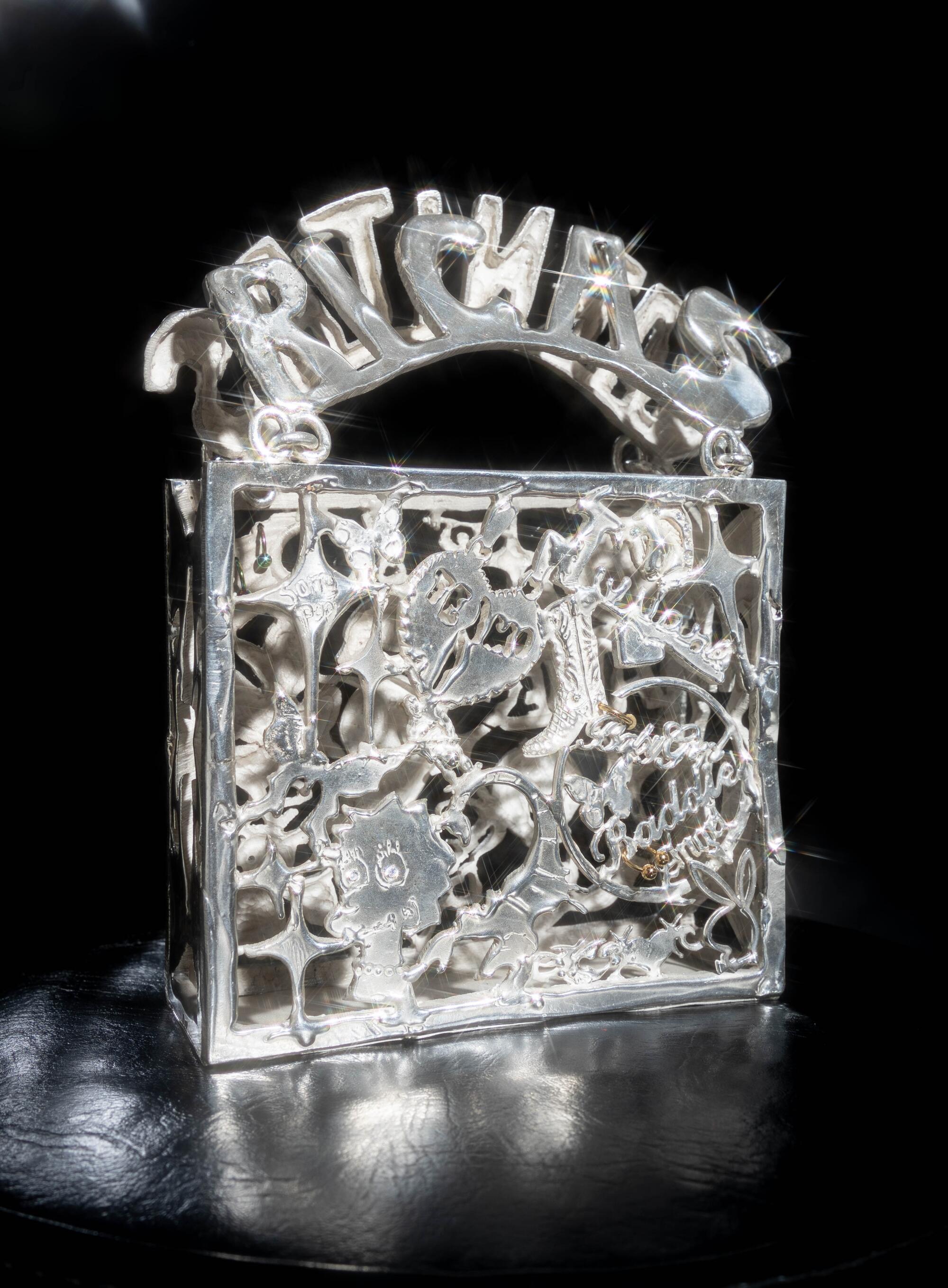 Photo of “KEPERRA” — a sterling silver casted purse made by Georgina Trevio for Image magazine.