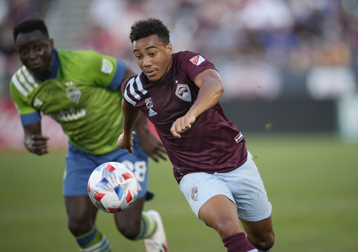 Colorado Rapids forward Jonathan Lewis, front, pursues the ball with Seattle Sounders defender Yeimar Gomez in the first half of an MLS soccer match Sunday, July 4, 2021, in Commerce City, Colo. (AP Photo/David Zalubowski)