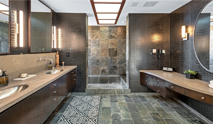 The hillside home includes three levels of decks, balconies and patios, as well as a swimming pool and spa.