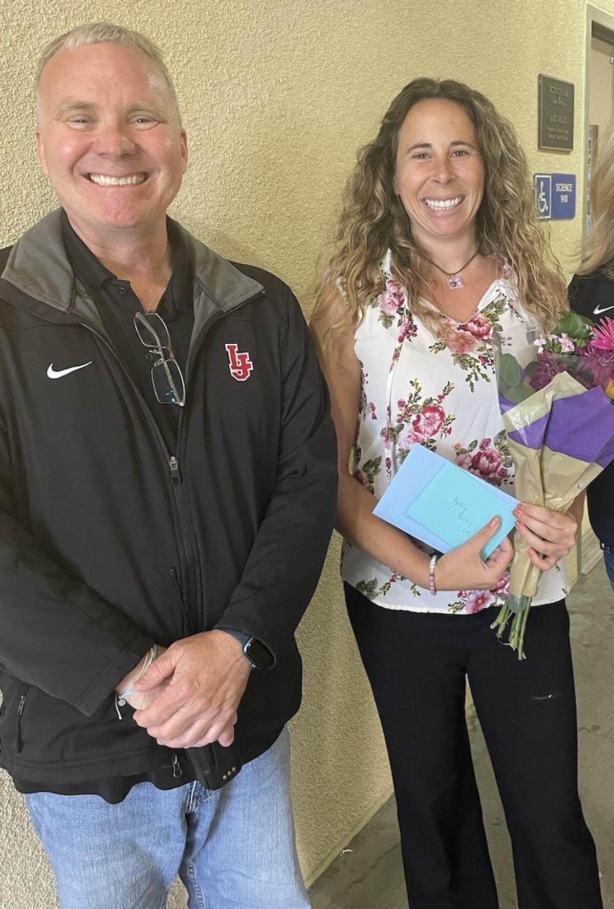 La Jolla High School Principal Chuck Podhorsky congratulates the school's Teacher of the Year, Kelley Bailey.