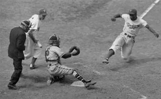 Jackie Robinson steals home during a baseball game in New York