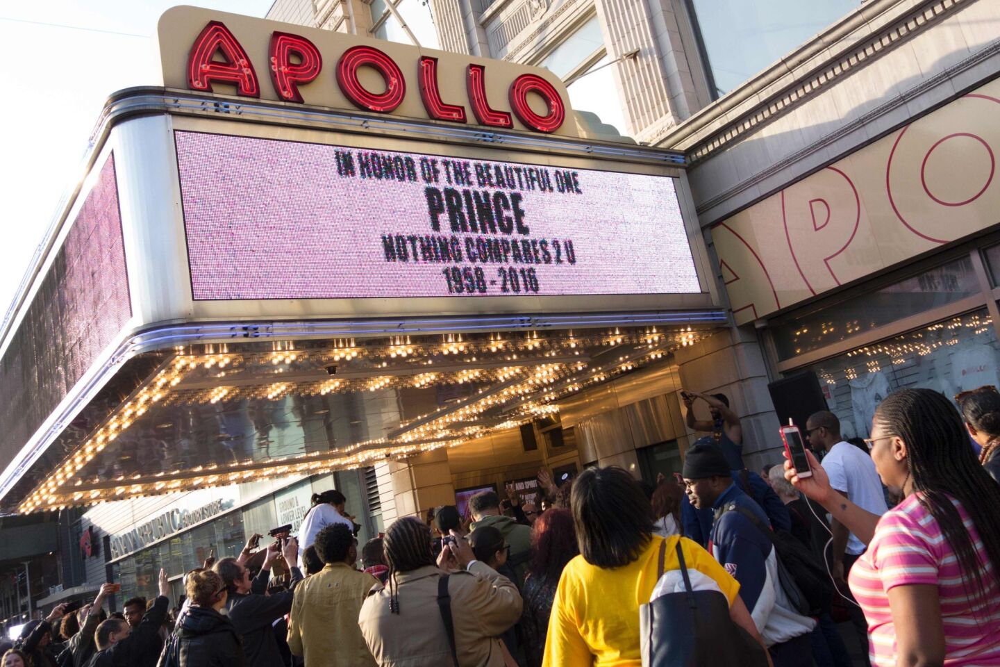 People gather outside the Apollo Theater in New York.