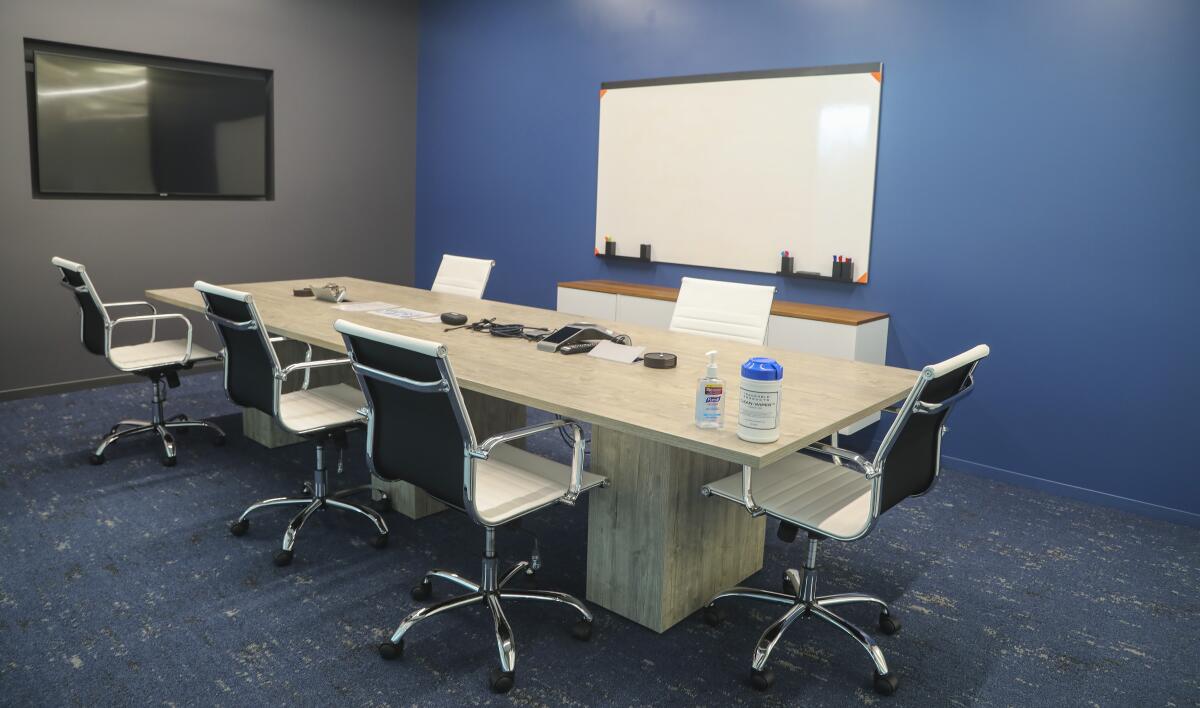  A meeting room with distanced seats and sanitizers for workers at Truvian.