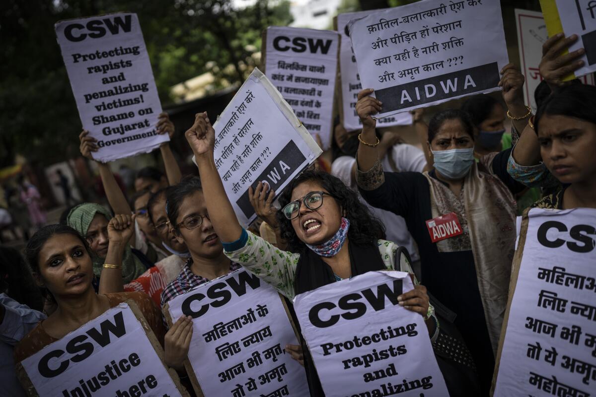 Activists shout slogans against the remission of sentence by the government to convicts of a gang rape, in New Delhi, India, Thursday, Aug. 18, 2022. A Muslim woman who was gang raped while pregnant during India's devastating 2002 religious riots has appealed to the government to rescind its decision to free the 11 men who had been jailed for life for committing the crime, after they were released on suspended sentences. The 11 men, released on Monday when India celebrated 75 years of independence, were convicted in 2008 of rape, murder and unlawful assembly. (AP Photo/Altaf Qadri)
