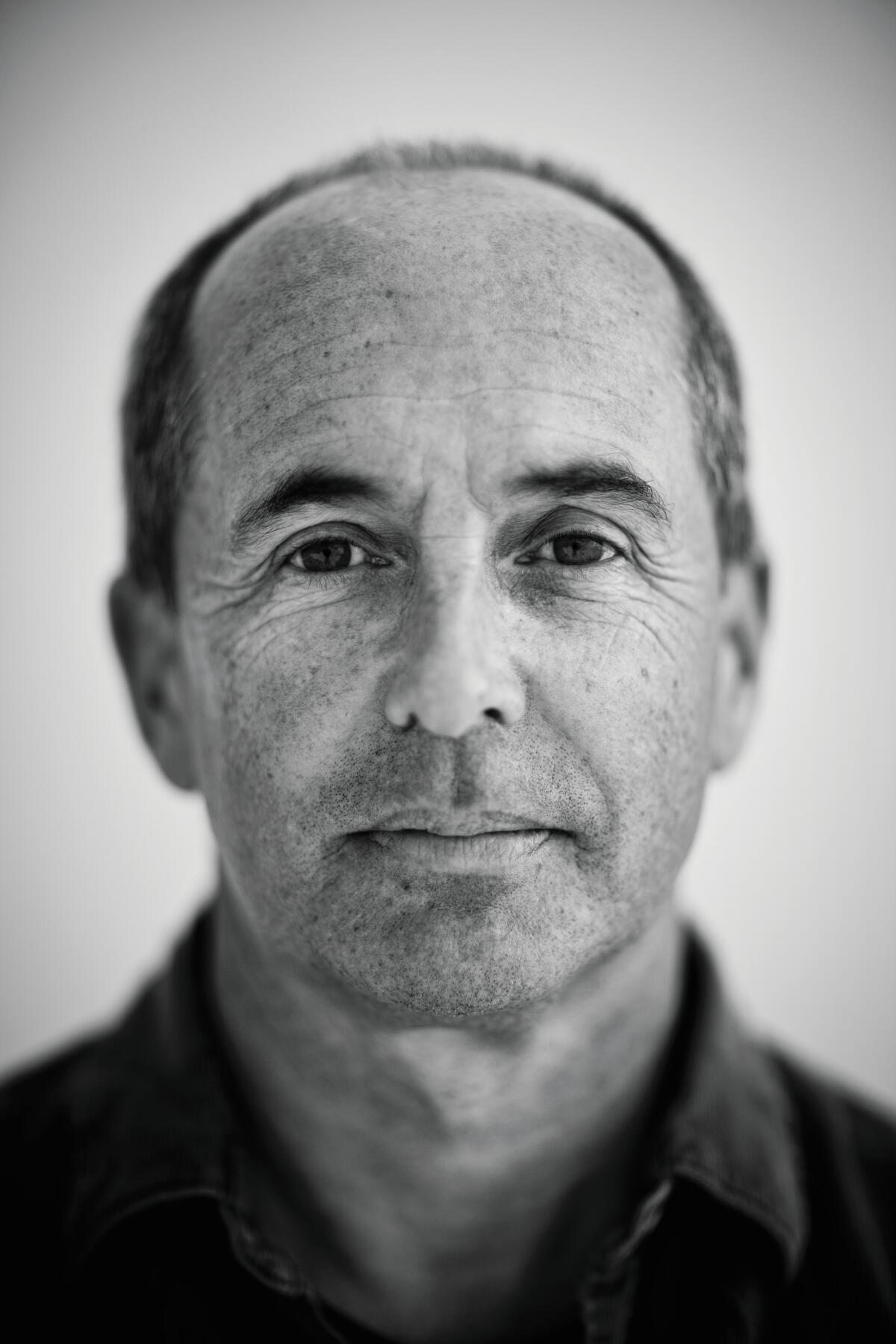 A black-and-white headshot of a man.