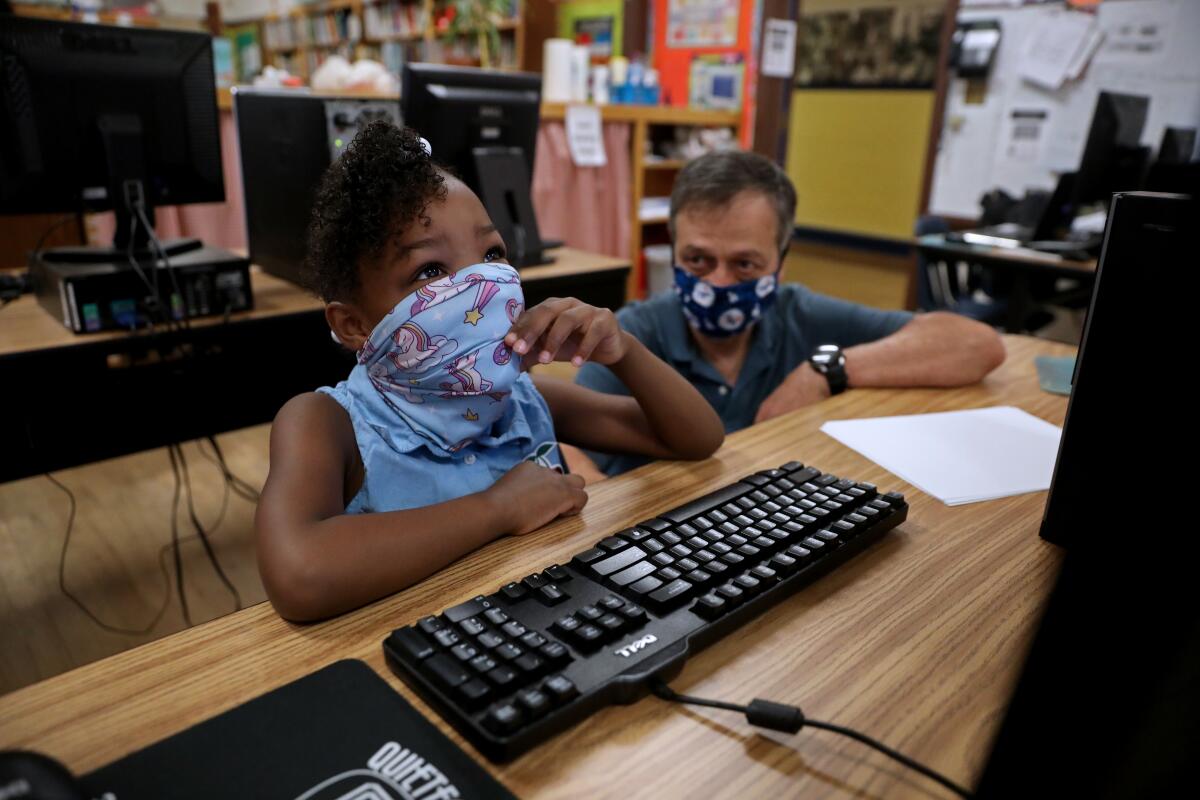 A child sits at a computer.