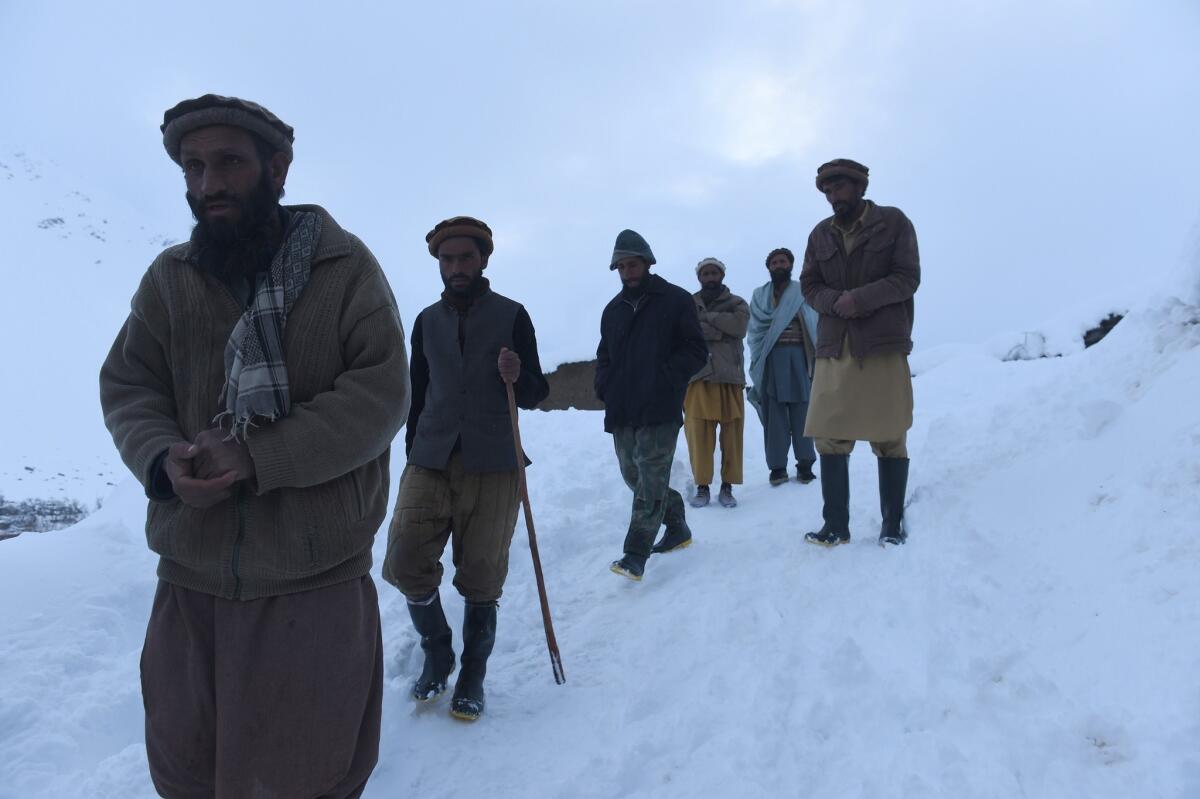 Men search for victims of avalanches in Afghanistan's Panjshir province on Feb. 25.