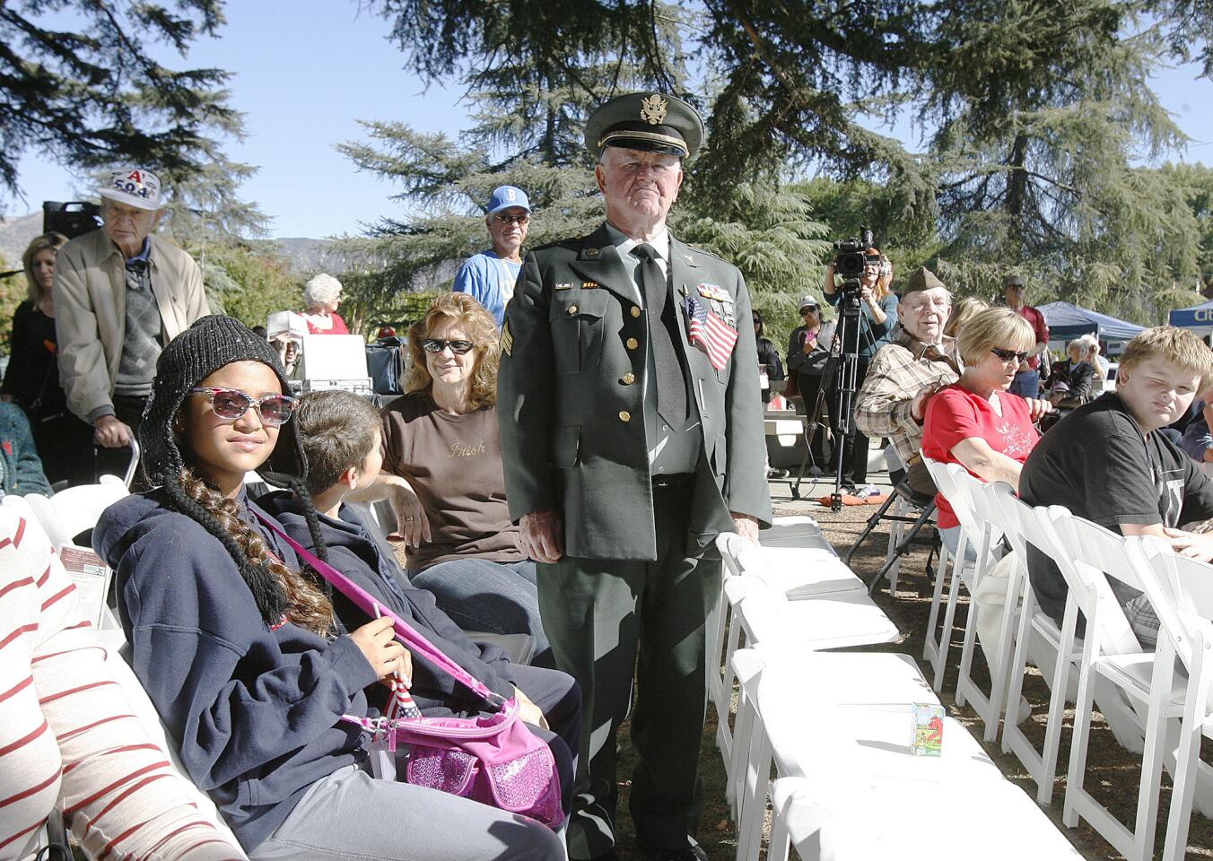Ray Ackerman, of Burbank, who served in the Army in 1951, stands as the military anthem for the Army, "The Army Song" is played and sung at the Veterans Day Ceremony at McCambridge Park War Memorial in Burbank on Monday November 12, 2012. The event was sponsored by the City of Burbank and the Burbank Veterans Committee.