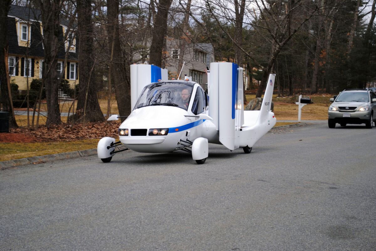 Terrafugia Inc.'s prototype flying car, dubbed the Transition, travels down a street with its wings folded. Crowdfunding is attractive to start-ups such as Terrafugia, says the company's co-founder, Carl Dietrich. "For publicly traded companies, individual investors don't have the ability to influence the success and failure of a company," Dietrich said. "But for small start-ups, they absolutely have the ability to influence success and failure. That's exciting and something we haven't seen before."