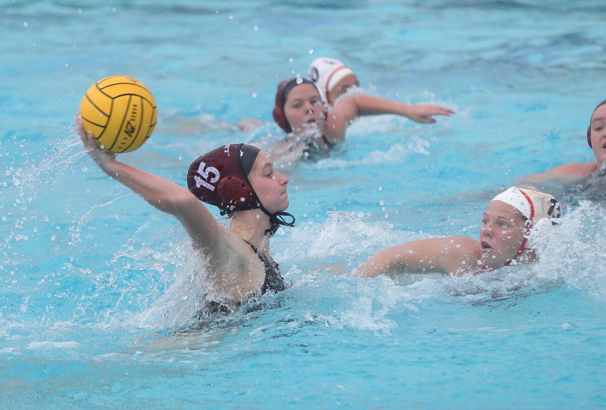 Laguna Beach's Kara Carver (15) shoots and scores during the semifinals of the Bill Barnett Holiday Cup on Friday.