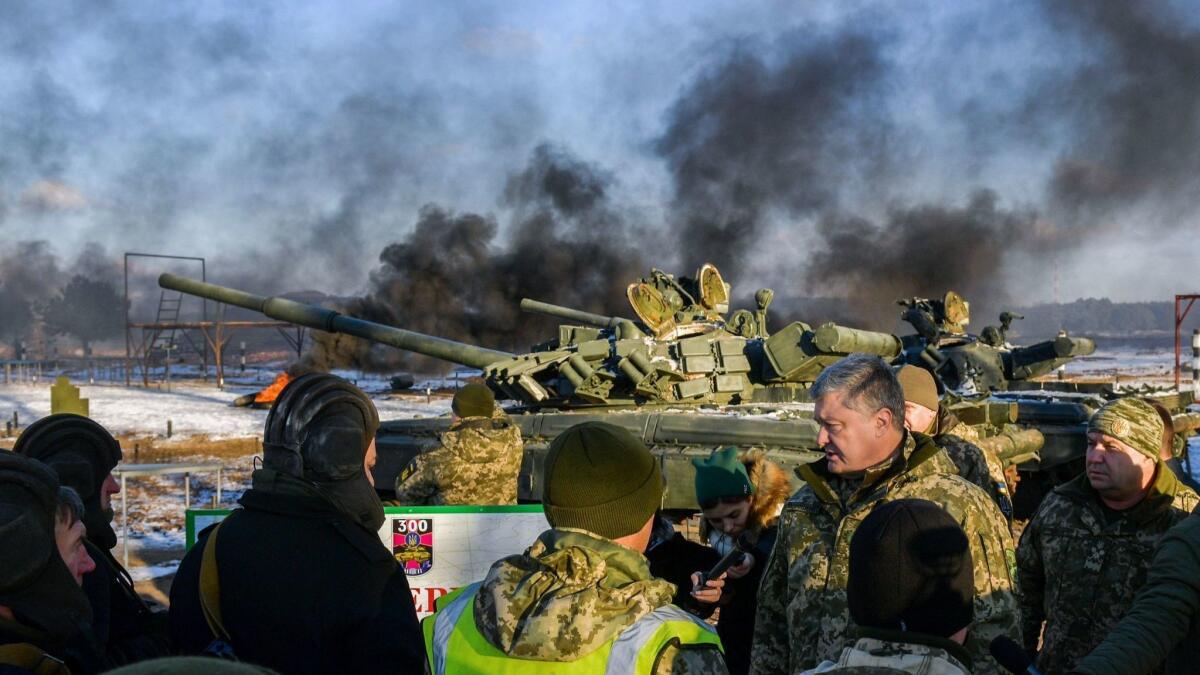President Petro Poroshenko talks with tank operators during drills near the city of Chernihiv in northern Ukraine on Wednesday.