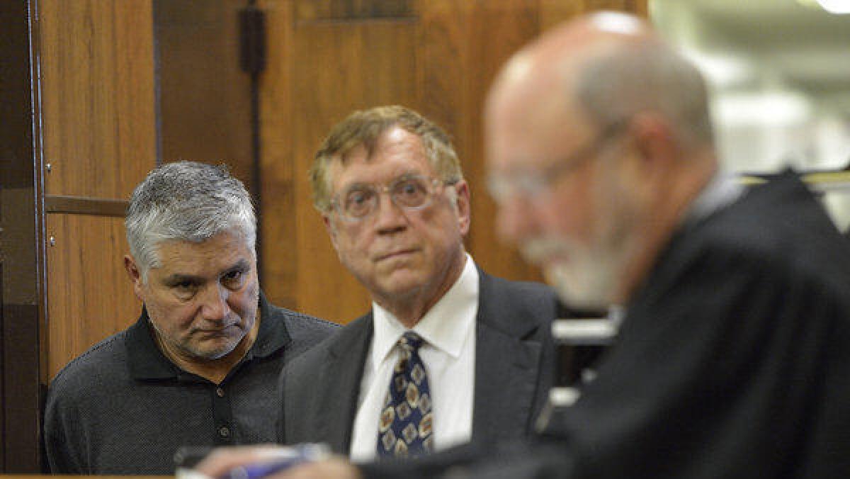 Former teacher Robert Pimentel, left, with attorney Richard Knickerbocker, center, appears in court in 2013.