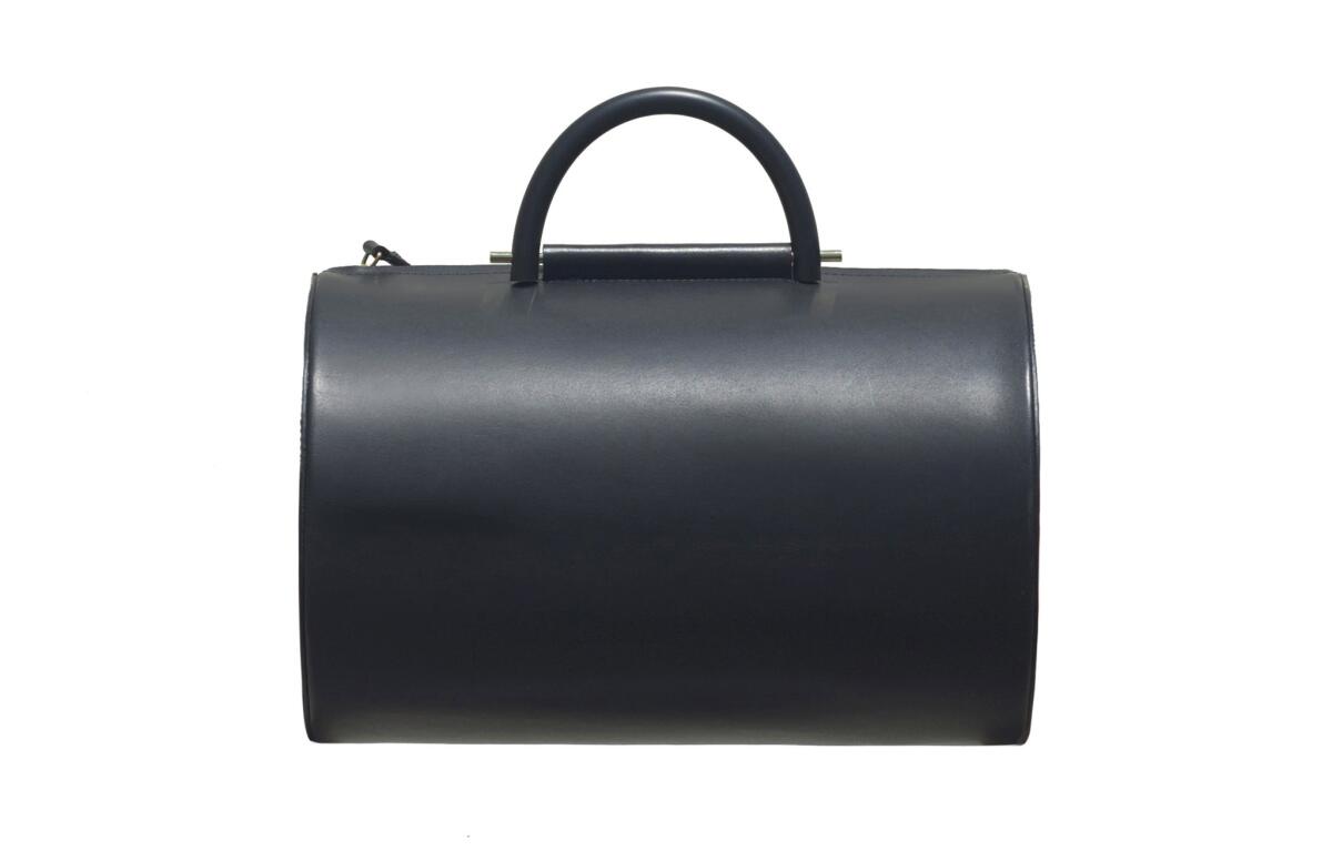 Building Black leather Cylinder duffel bag with rubber handles and brass hardware, $795 at Building Block in Los Angeles, (323) 803-3420, building- -block.com