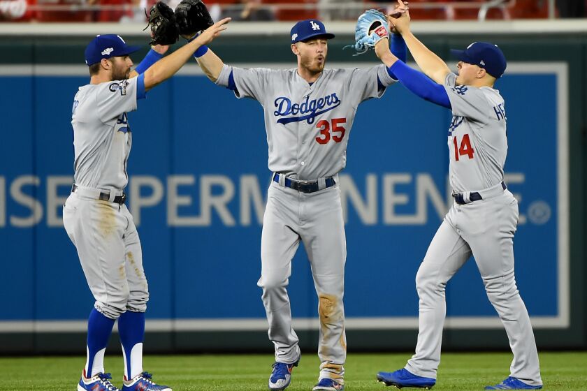 WASHINGTON, DC - OCTOBER 06: (L-R) Chris Taylor #3, Cody Bellinger #35 and Kike Hernandez #14 of the Los Angeles Dodgers celebrate after the final out of Game 3 of the NLDS to defeat the Washington Nationals 10-4 at Nationals Park on October 06, 2019 in Washington, DC. (Photo by Will Newton/Getty Images)