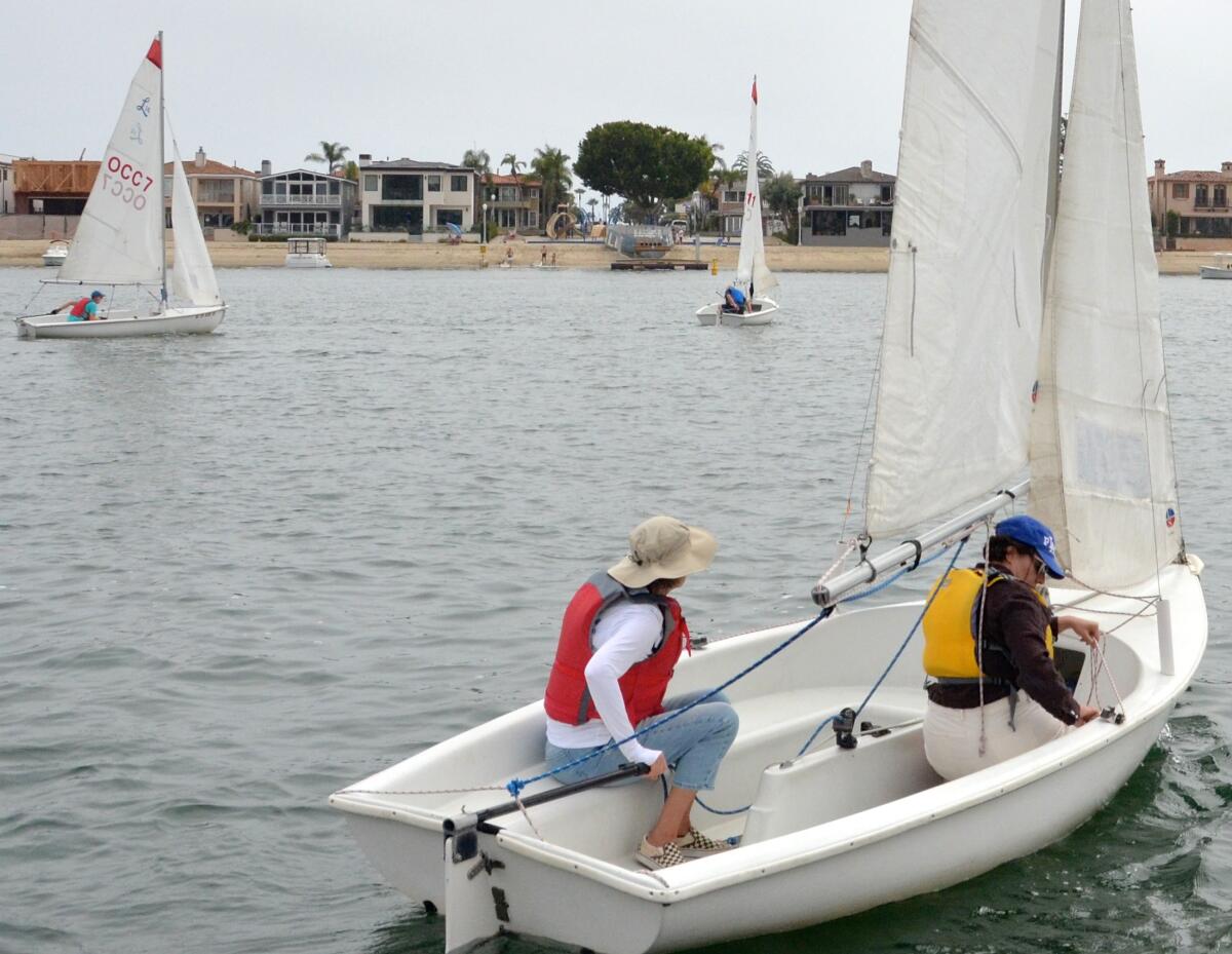 Classmates Ingrid Vallejo, right, and her daughter, Audrey, sail in Newport Harbor.