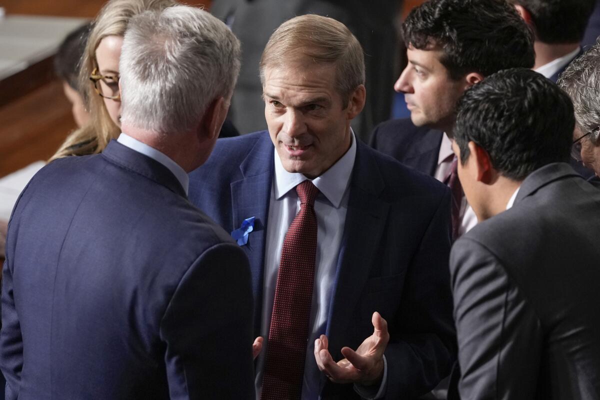 Rep. Jim Jordan talks with Republican colleagues as they try to elect him speaker on Oct. 18. 
