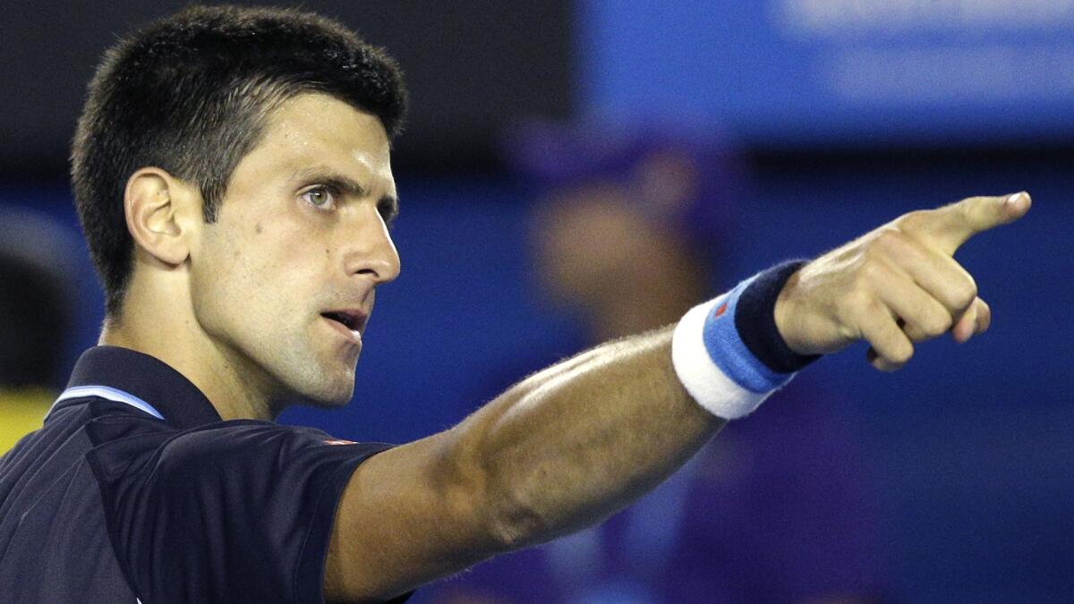Novak Djokovic points toward his coach in the stands after defeating Fernando Verdasco in the fourth round of the Australian Open on Saturday.