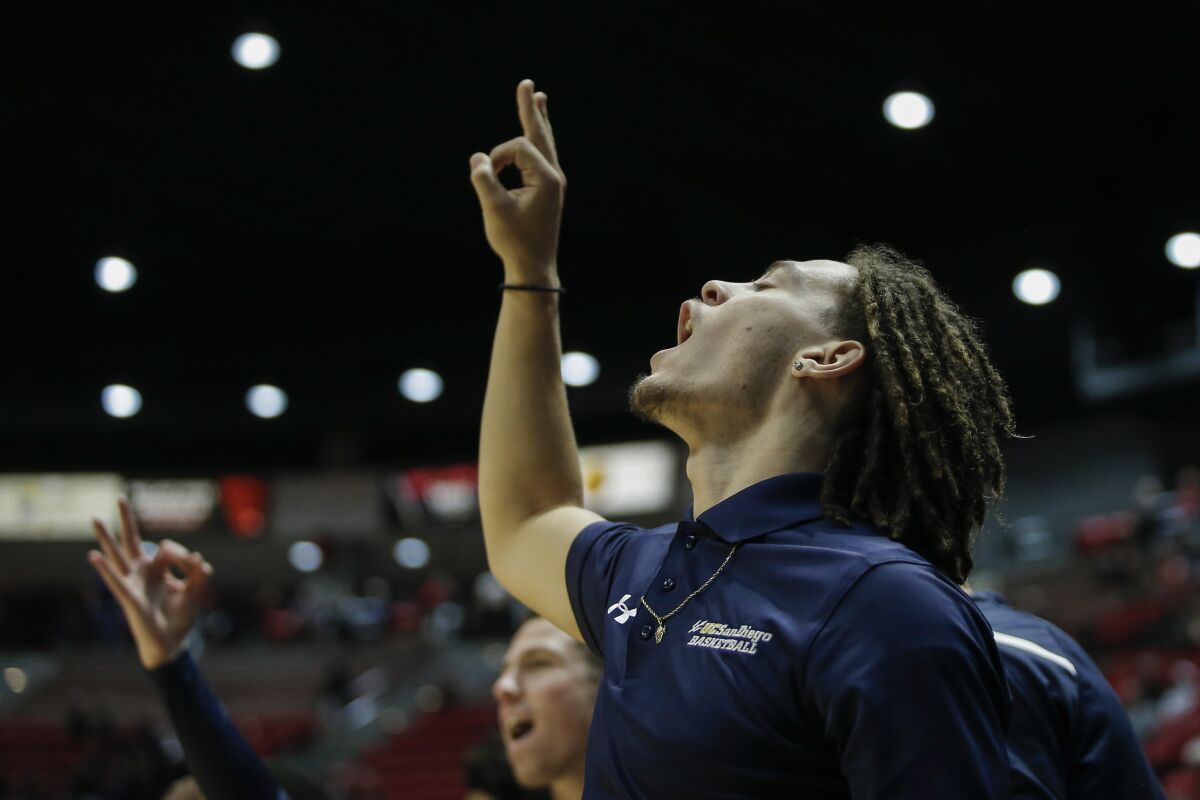 UCSD guard Tyrell Roberts cheers from the bench after a three pointer against SDSU last season.