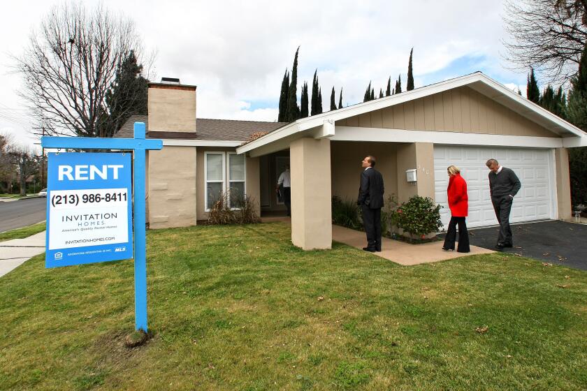 CANOGA PARK, CA-FEBRUARY 8, 2013: Officials from Invitation Homes, tour a home on Casaba Ave. in Canoga Park that the company recently bought, fixed up and turned into a rental property. Invitation Homes is a subsidiary of the hedge fund Blackstone. (Mel Melcon/Los Angeles Times). Original caption: Left to right-Mark Beisswanger, (now former) Chief Operating Officer of Invitation Homes, Cassandra Bujarski, principal, Sard Verbinnen & Co, and Eric Elder, Vice President of Marketing and Communications, Invitation Homes, tour a home on Casaba Ave. in Canoga Park that the company recently bought, fixed up and turned into a rental property. Invitation Homes is a subsidiary of the hedge fund Blackstone. (Mel Melcon/Los Angeles Times)