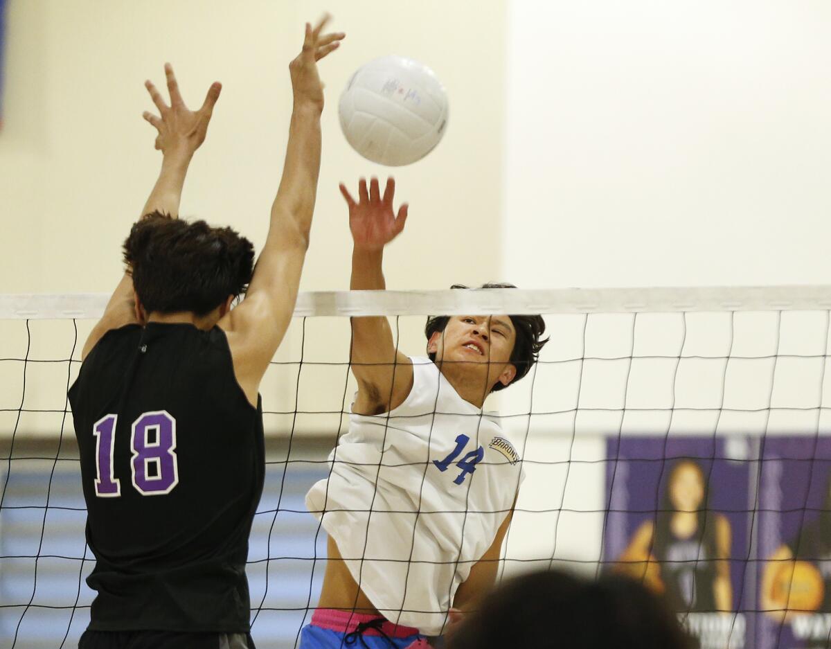 Fountain Valley's Joseph Nguyen (14) puts a kill past Portola's Garbriel Kluber Martinez (18) on Thursday.