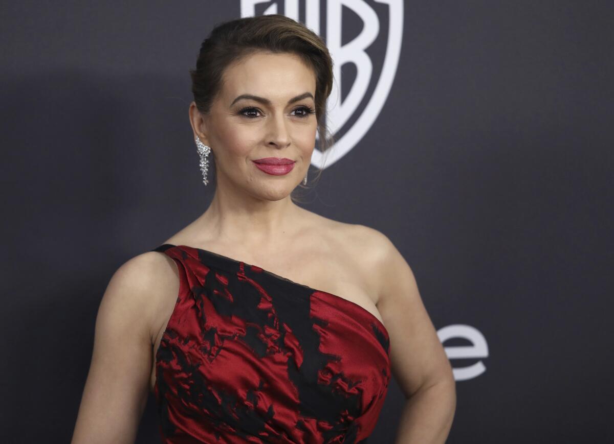 Alyssa Milano in a one-shoulder red dress