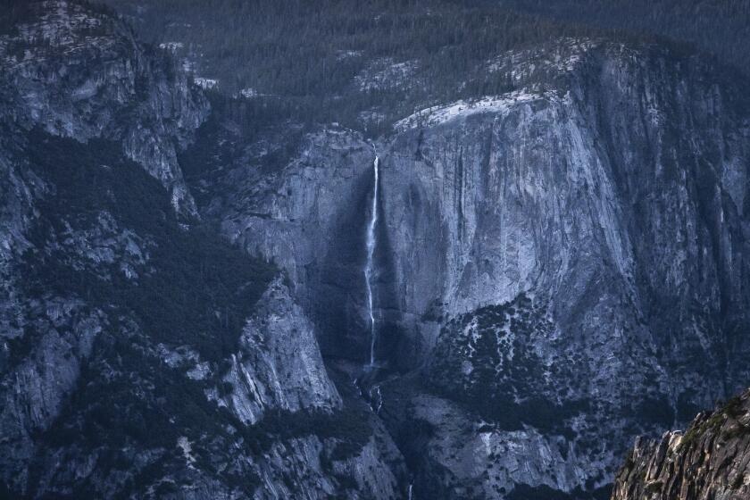 In this Saturday, June 12, 2021, photo provided by Scott Oller Films, highliner Daniel Monterrubio walks the 2,800-foot-long line off Taft Point above Yosemite Valley in Yosemite, Calif. (Scott Oller/Scott Oller Films via AP)