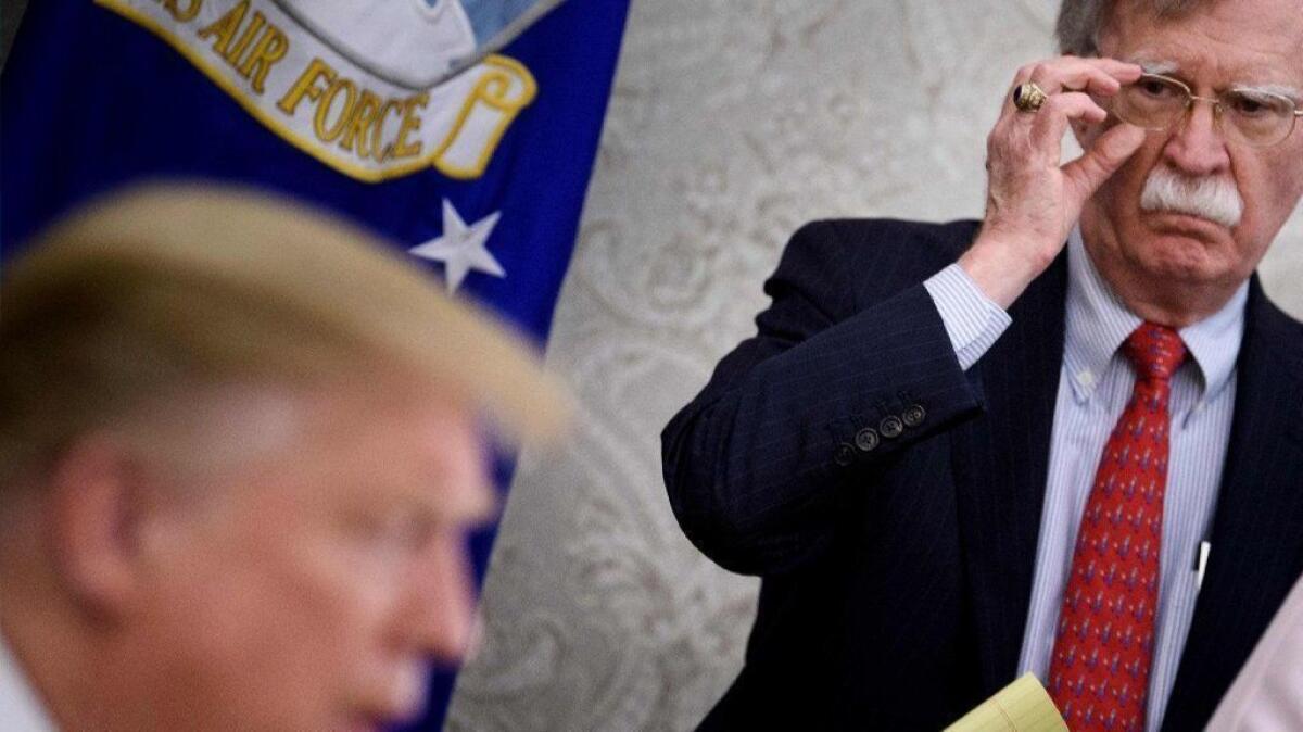 National security advisor John Bolton listens while President Trump speaks at the White House on May 13.