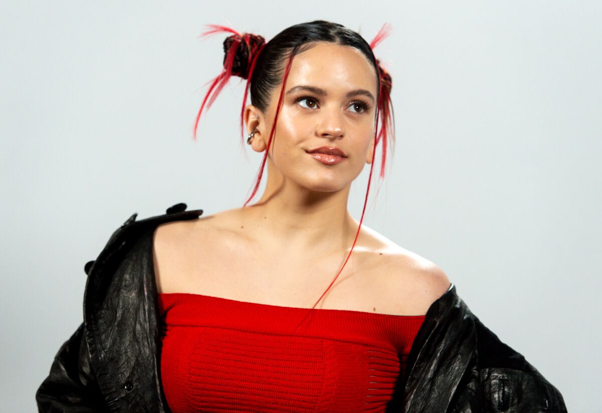 A woman in a red top and a black leather jacket