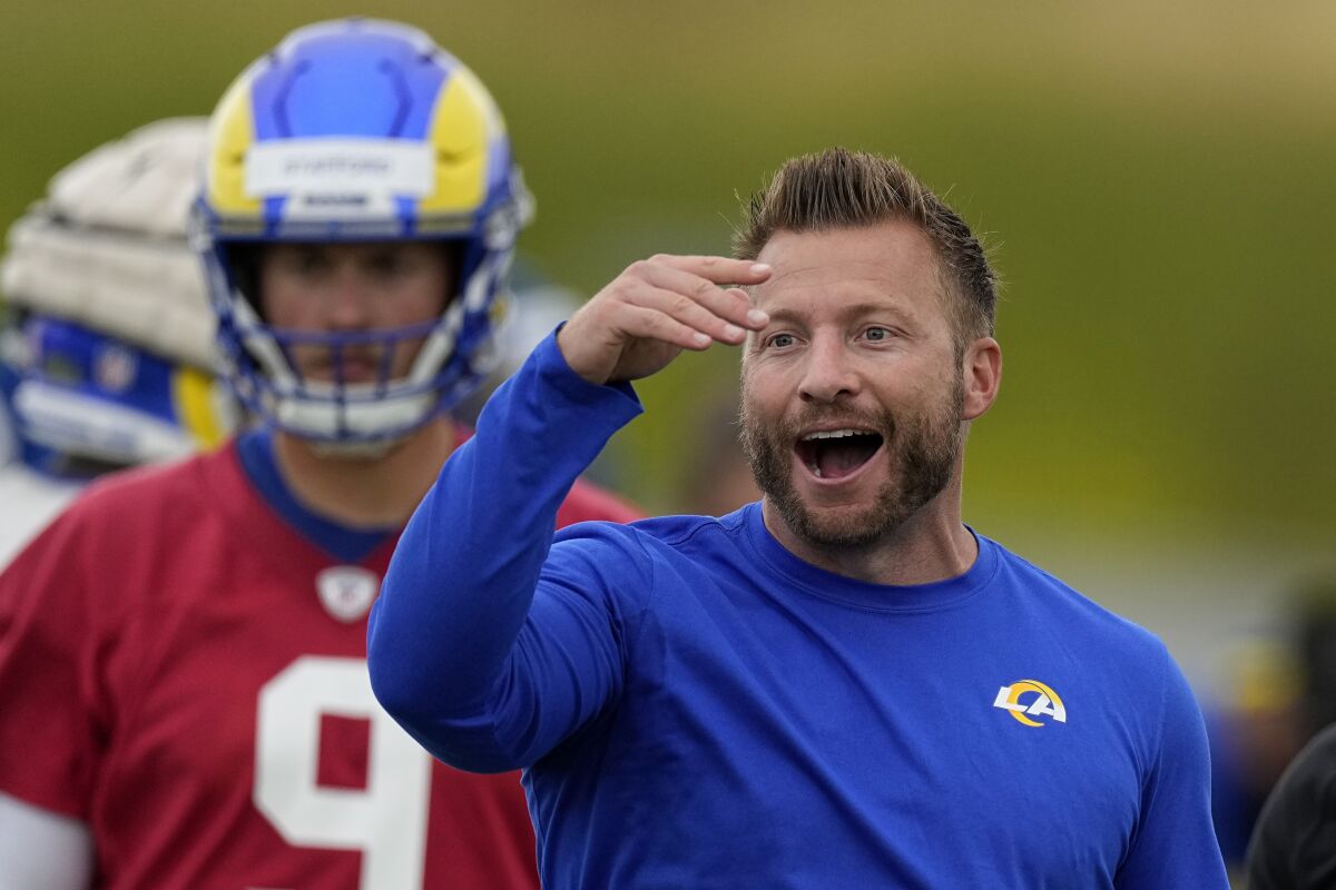 Rams coach Sean McVay gestures as quarterback Matthew Stafford stands in the background.